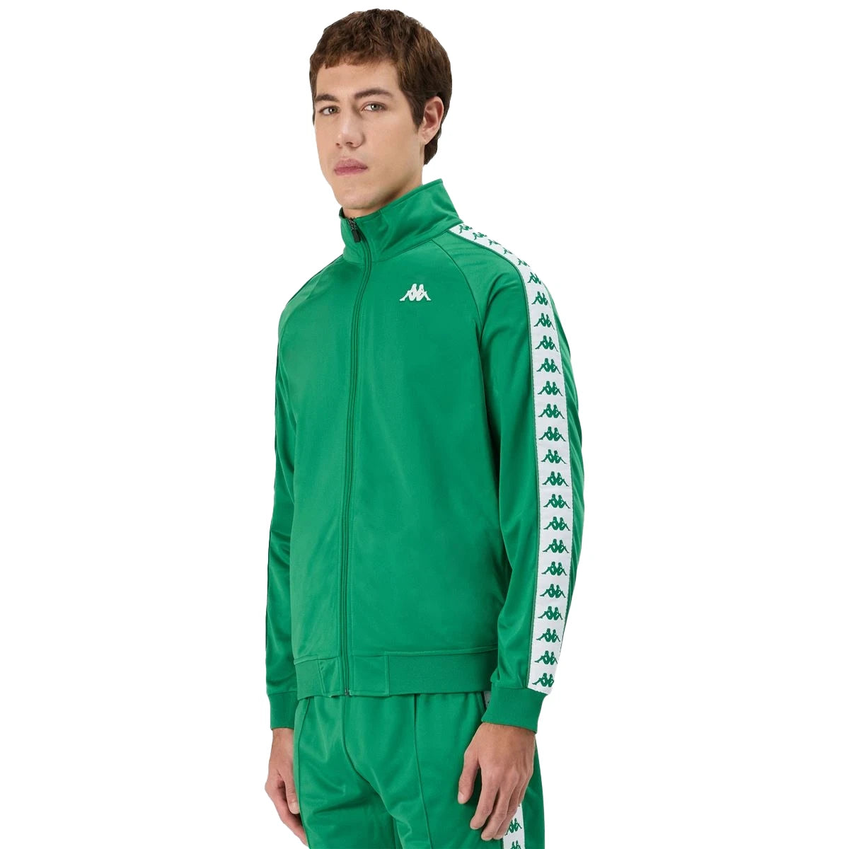 Man wearing green Kappa track jacket with white and green banda going down the arms and Omini logo in white on left side. Front view.