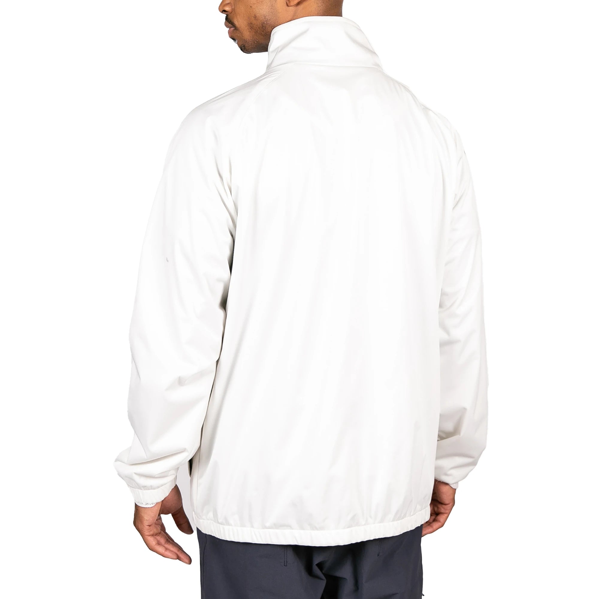 Male model wearing Arapi Modelo Jacket in white. Back view.
