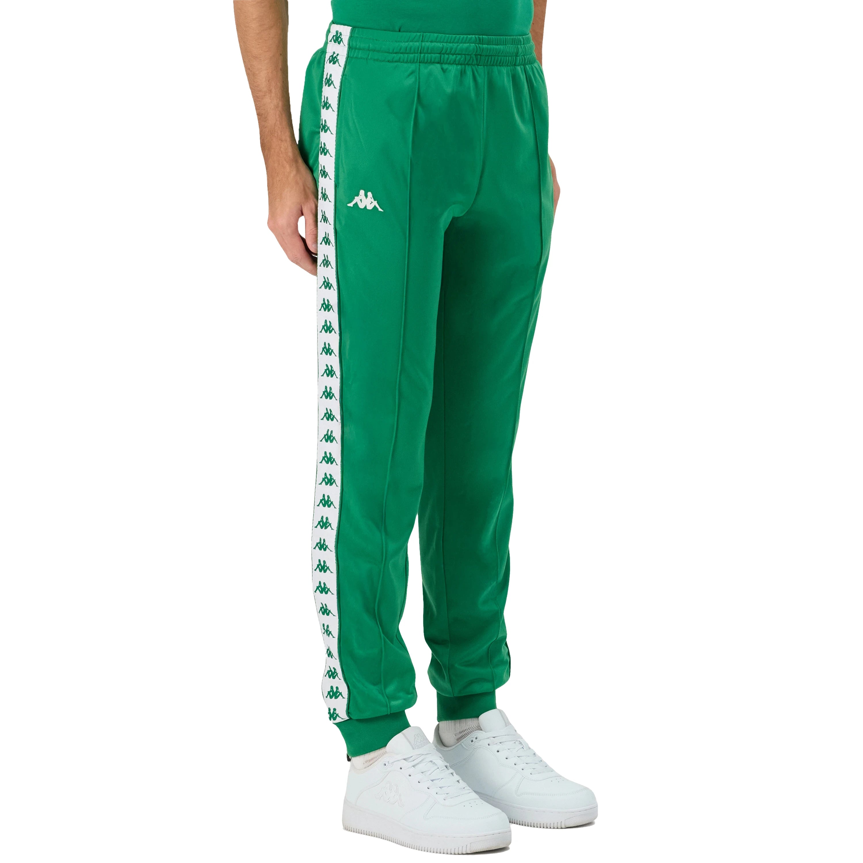 Man wearing Green Kappa track pants featuring Kappa Banda on side of legs in white and green. White Omini logo on right leg. Front side view.