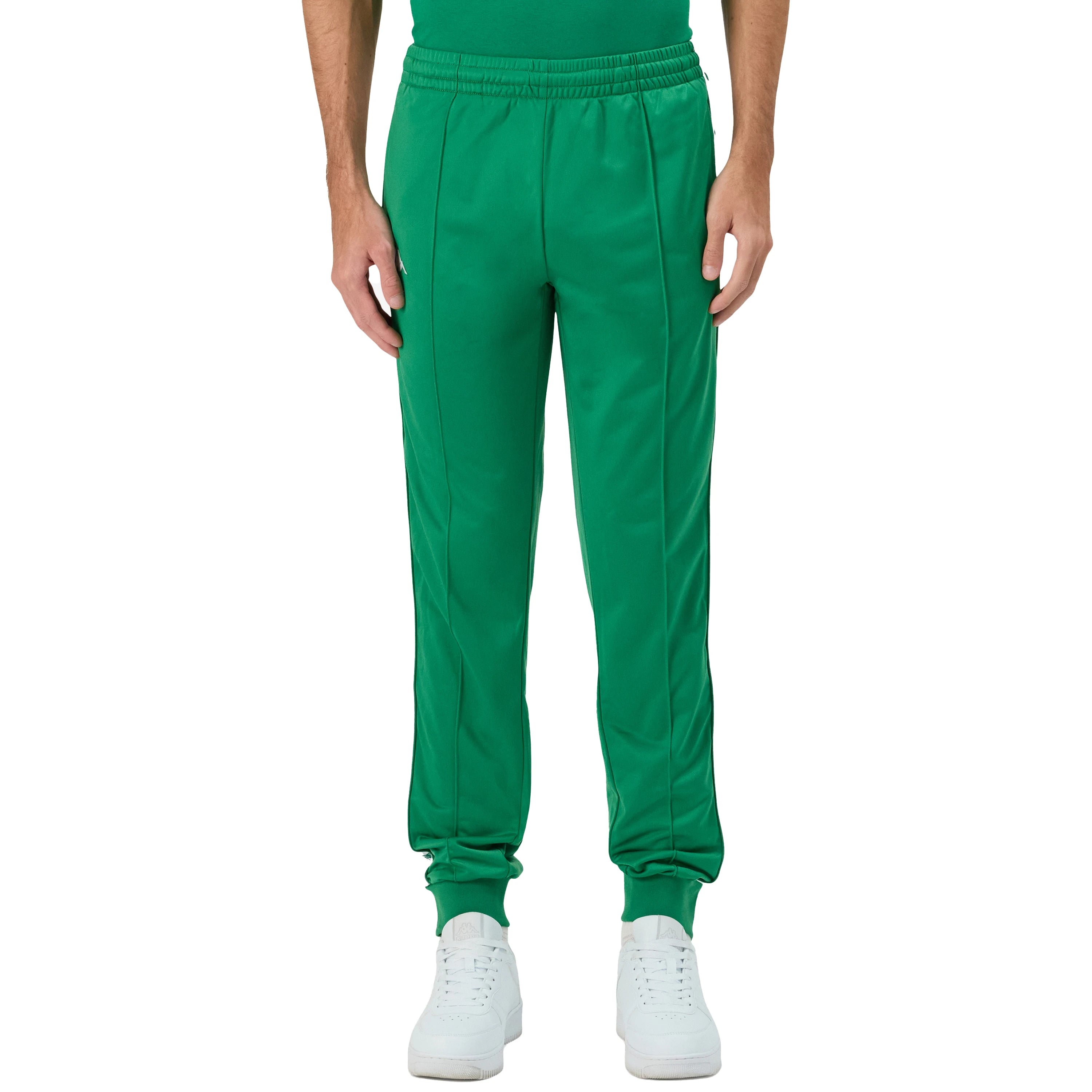 Man wearing Green Kappa track pants featuring Kappa Banda on side of legs in white and green. White Omini logo on right leg. Front view.