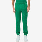 Man wearing Green Kappa track pants featuring Kappa Banda on side of legs in white and green. White Omini logo on right leg. Front view.