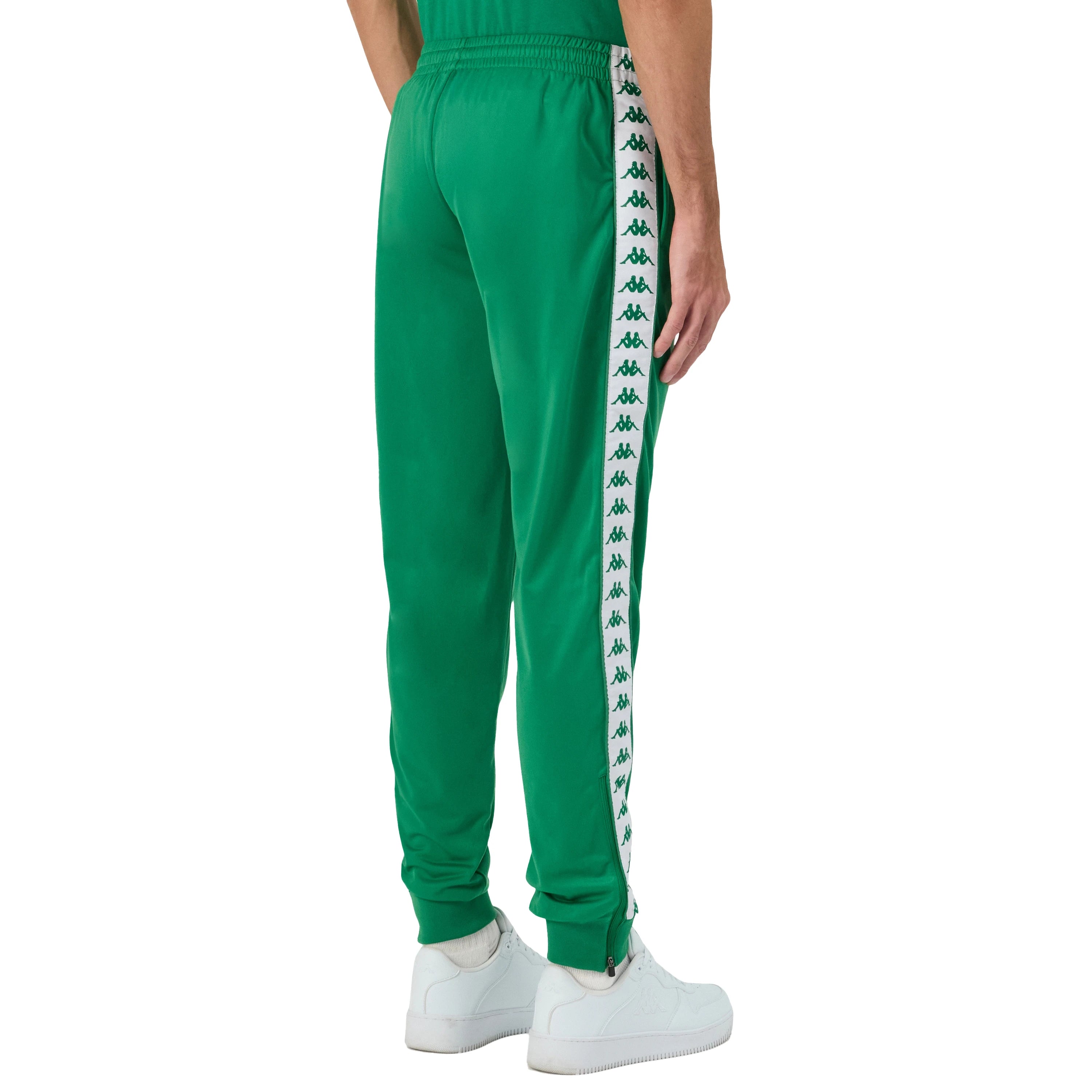 Man wearing Green Kappa track pants featuring Kappa Banda on side of legs in white and green. White Omini logo on right leg. Back side view.