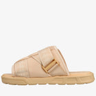 A single slide sandal in a light beige and tan colorway, featuring a wide adjustable strap with a tan buckle and a thick textured sole, shown against a plain white background.