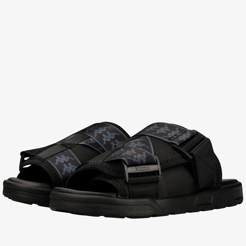 A pair of black Kappa slide sandals with gray and black logo-patterned straps, shown on a clean white background.