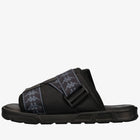 Black slide sandal with white logo on a white background