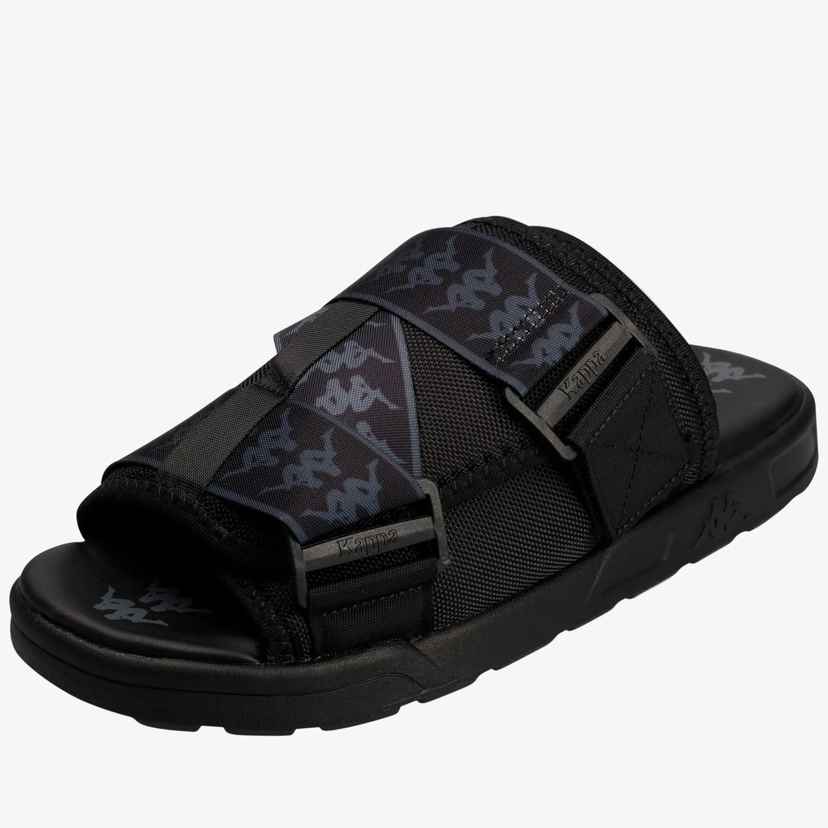 A black slide sandal with dark gray patterned straps and gray buckle details, shown from a three-quarters angle on a white background.