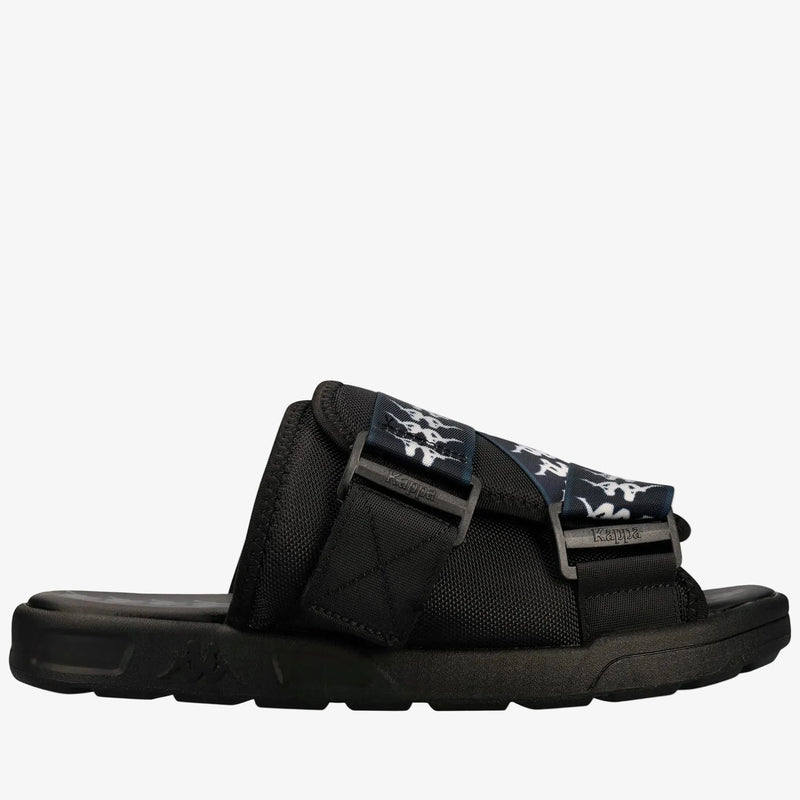 A black slide sandal with a wide strap featuring a navy blue and white graphic pattern, set against a plain white background.