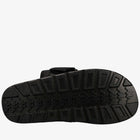 Black sandal sole with tread pattern on a white background