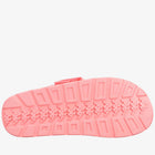 A single pink slip-on sandal shown from the sole view, featuring a textured tread pattern and a small matching pink strap at the top, isolated on a white background.
