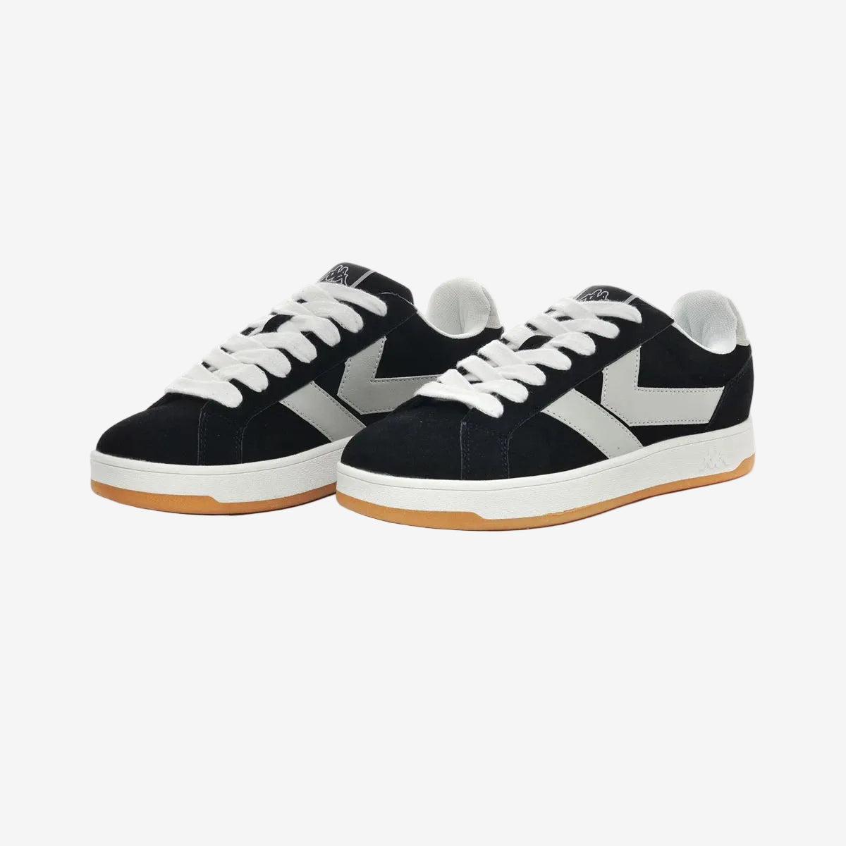 Black and white sneakers with gum sole on a white background