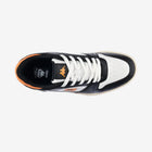 Black and white sneaker with orange accents on a white background