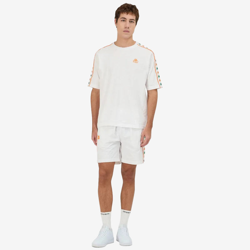 White shorts featuring Kappa Banda on the sides with green and orange omini logos. Full body view on model.