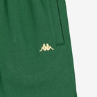 Detail view of golden yellow embroidered Kappa Omini logo on green shorts.