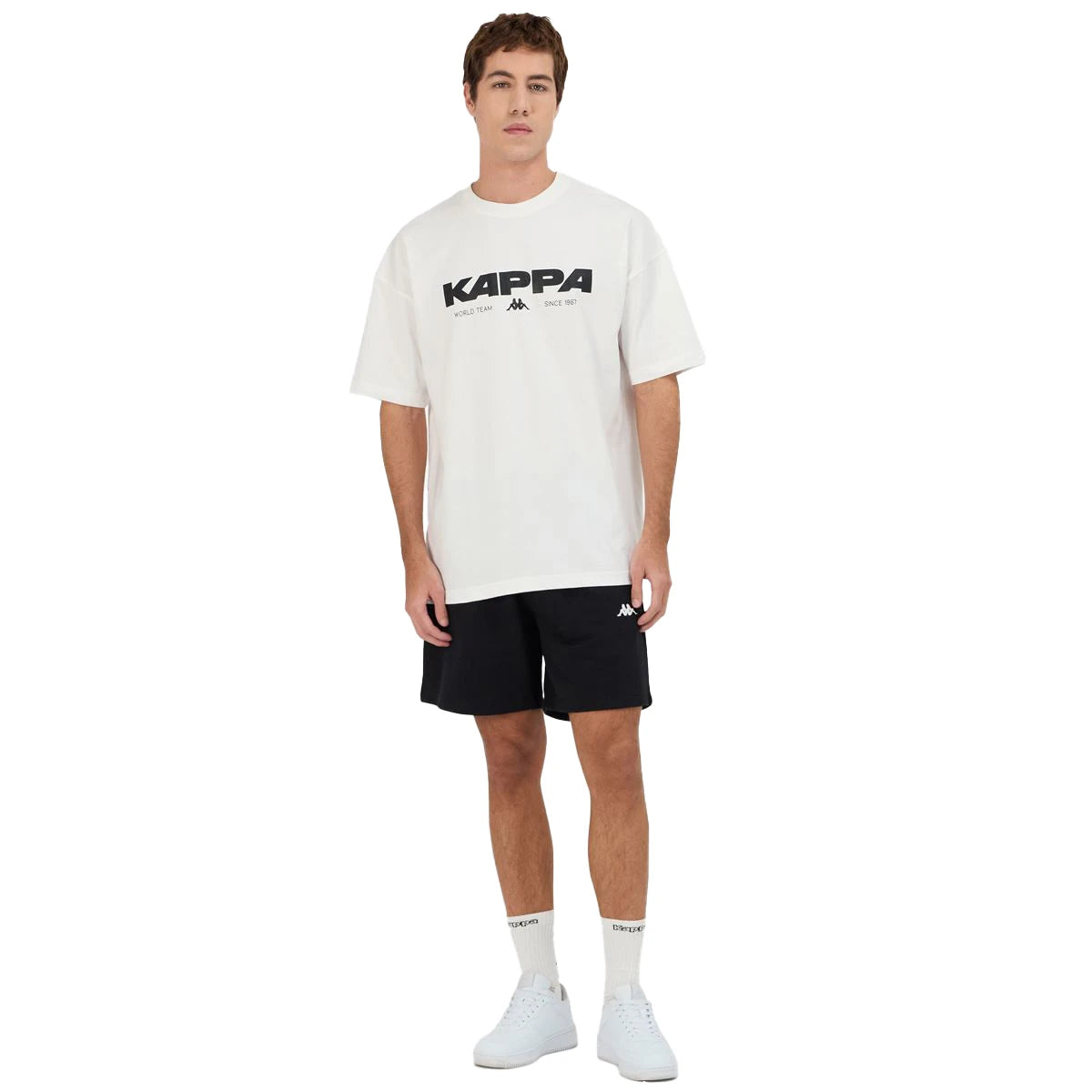 Man wearing Kappa Authentic Nhisso T-Shirt in White. Full body view.