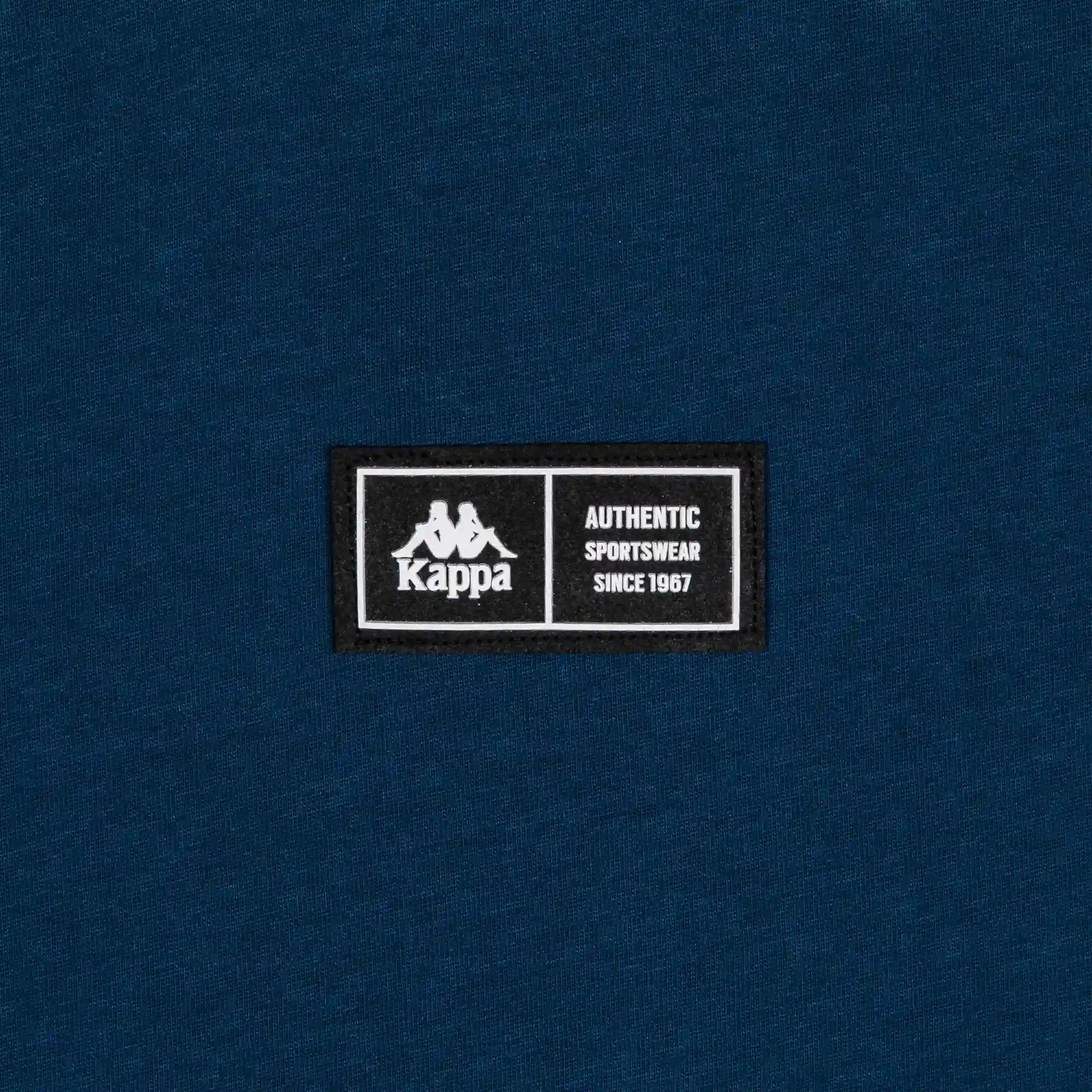 Detail view of silicone patch reading Kappa Authentic Sportswear since 1967.