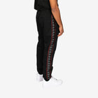 Black tracksuit with a patterned side stripe on a white background