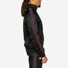 Person wearing a black tracksuit with red and gray accents on a white background