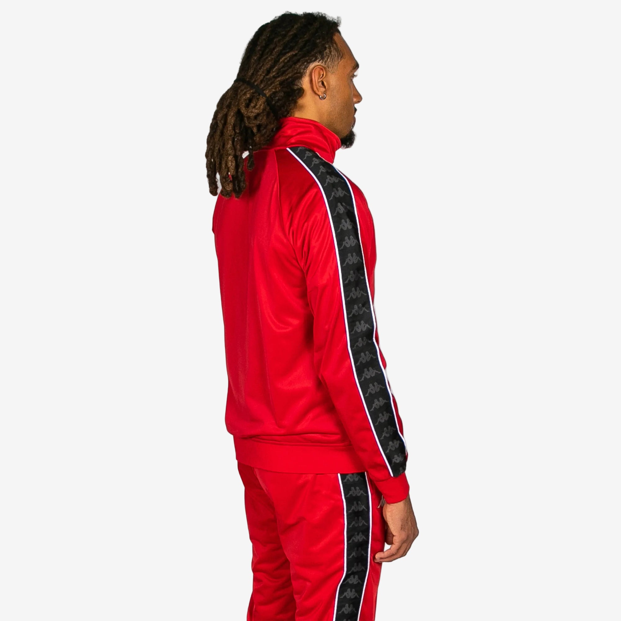 Person wearing a red tracksuit with black stripes on a white background