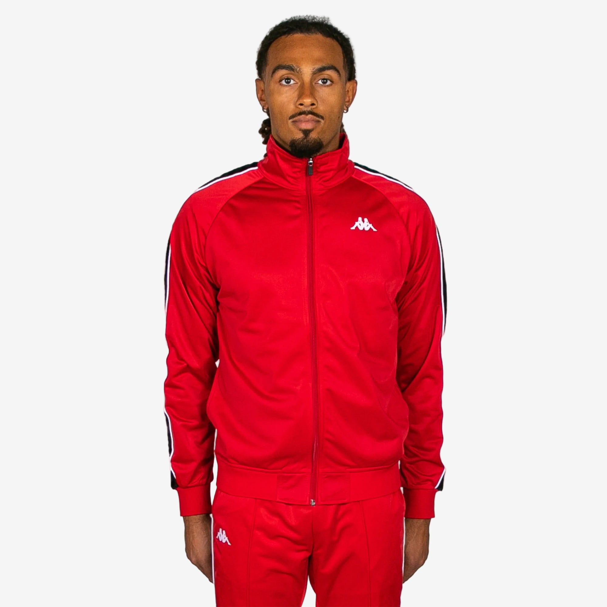 Person wearing a red tracksuit with a brand logo on a white background