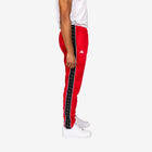 Red tracksuit pants with black side stripe and white logo on a white background