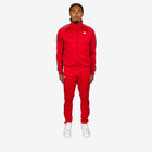 Person wearing a red tracksuit with white accents on a white background