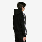 Person wearing a black hoodie with white logo details on sleeves against a white background