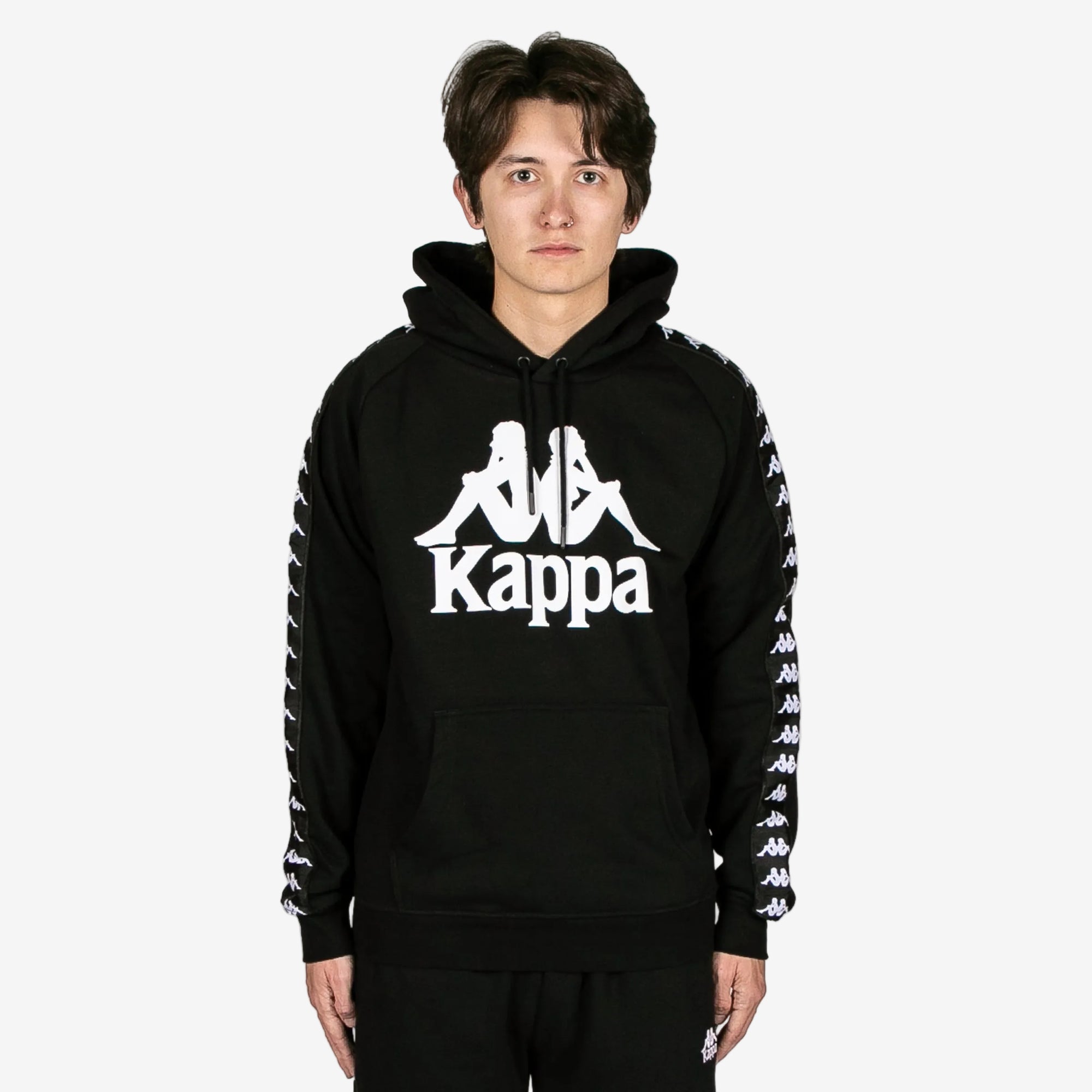 Person wearing a black hoodie with Kappa logo on a white background