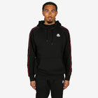 Person wearing a black hoodie with red stripes on a white background