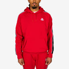 Person wearing a red tracksuit with a logo on a white background