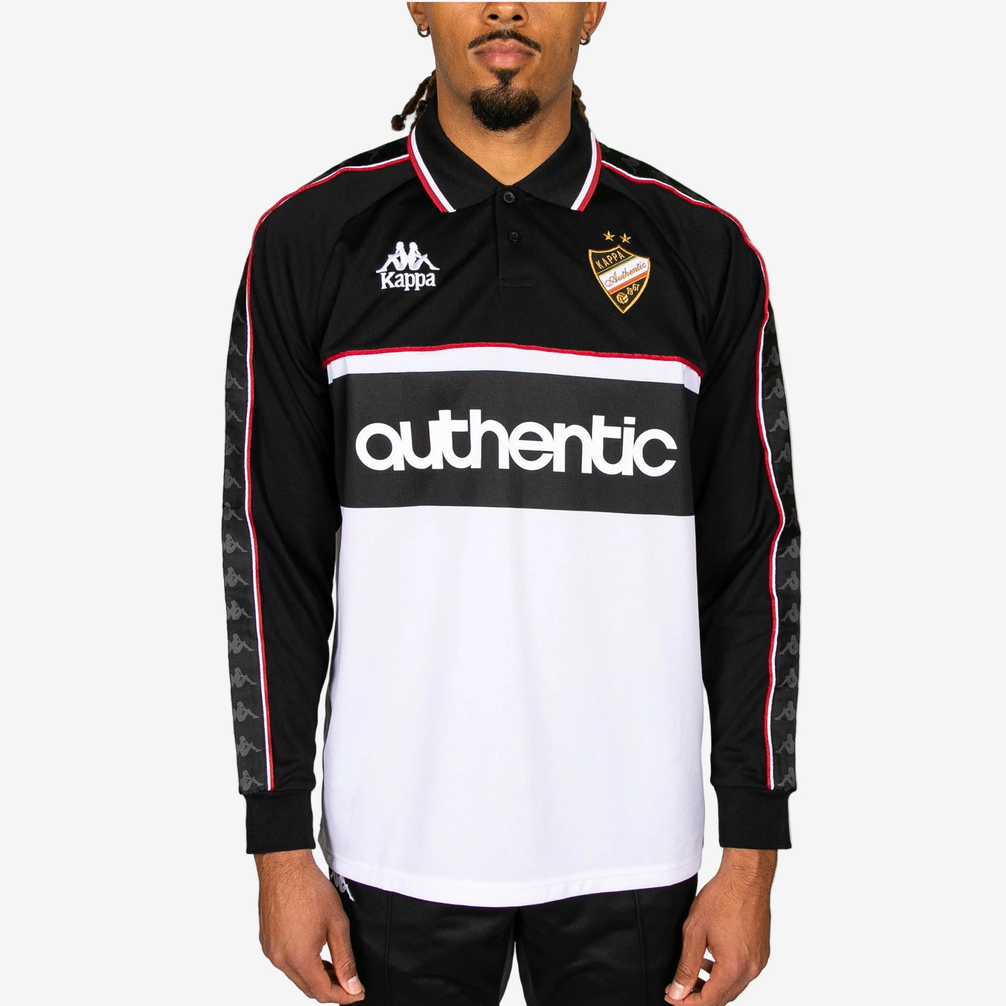 Person wearing a black and white sports jersey with 'Kappa' branding and 'authentic' text.