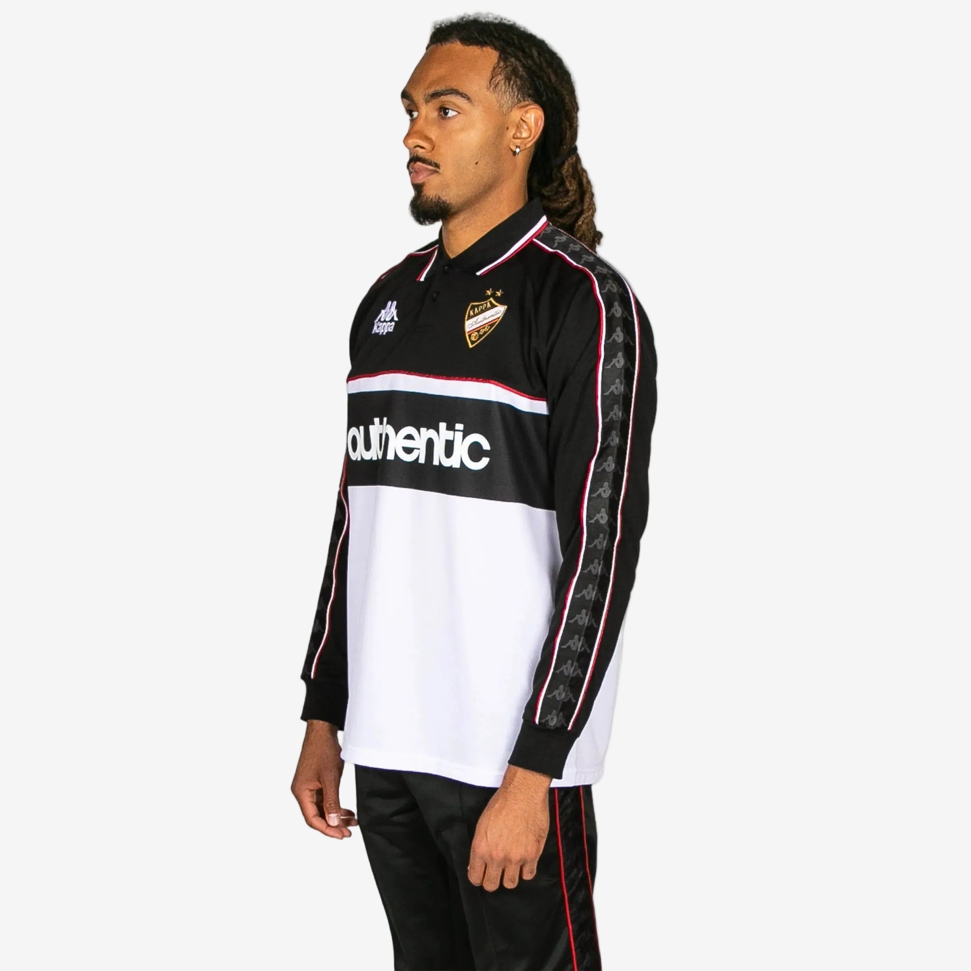Person wearing a black and white sports jersey with 'Kappa' branding on a white background