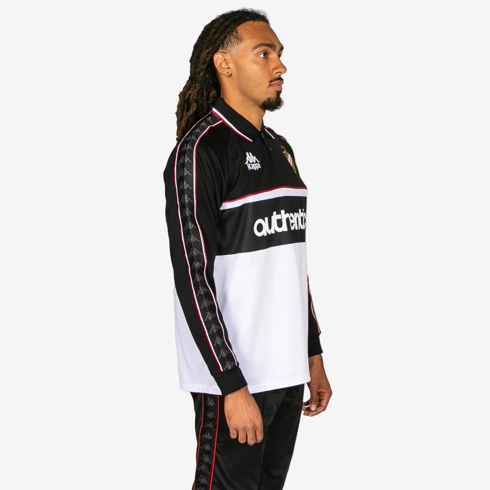 Person wearing a black and white sports jersey with visible branding on a white background