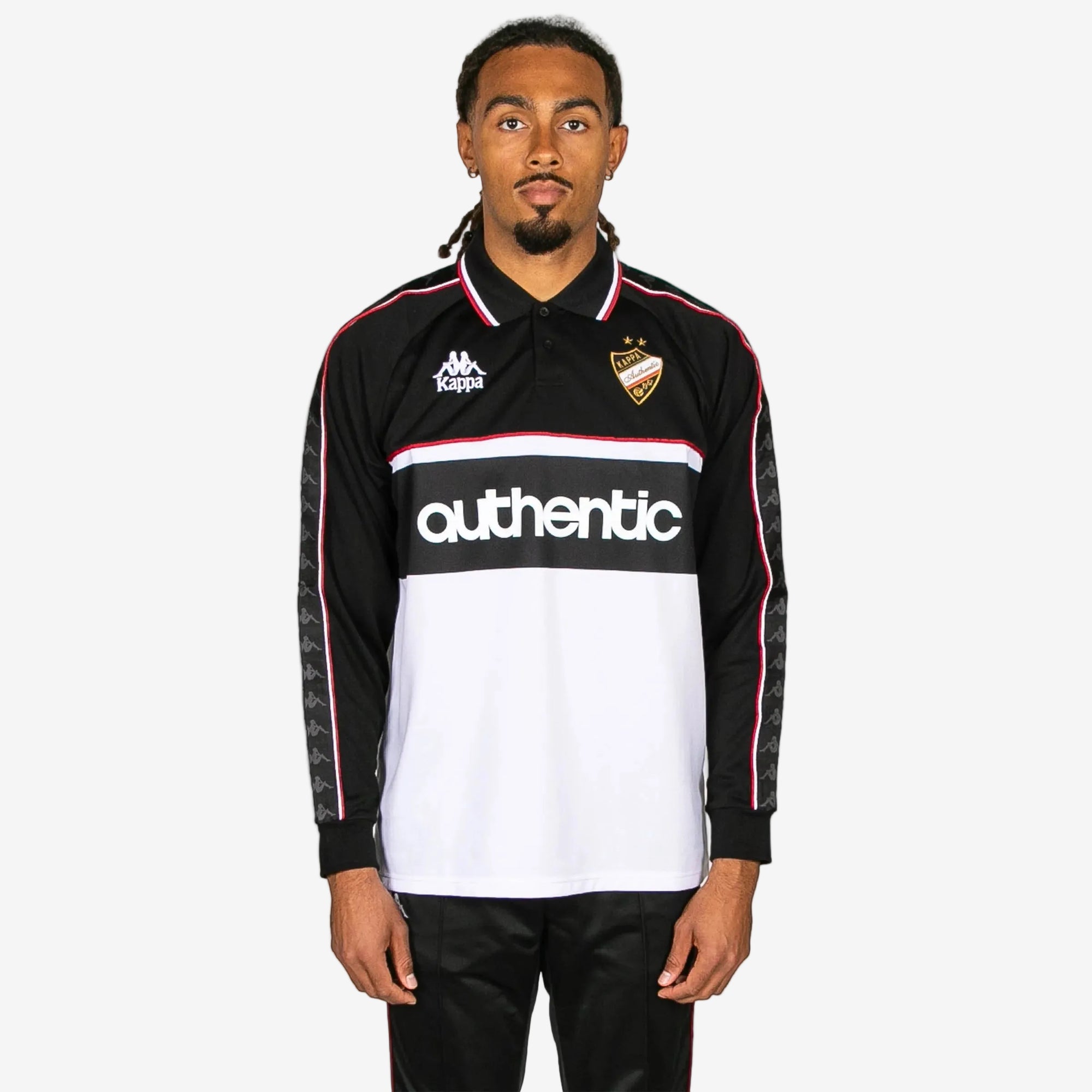Person wearing a black and white sports jersey with 'Kappa' branding on a white background