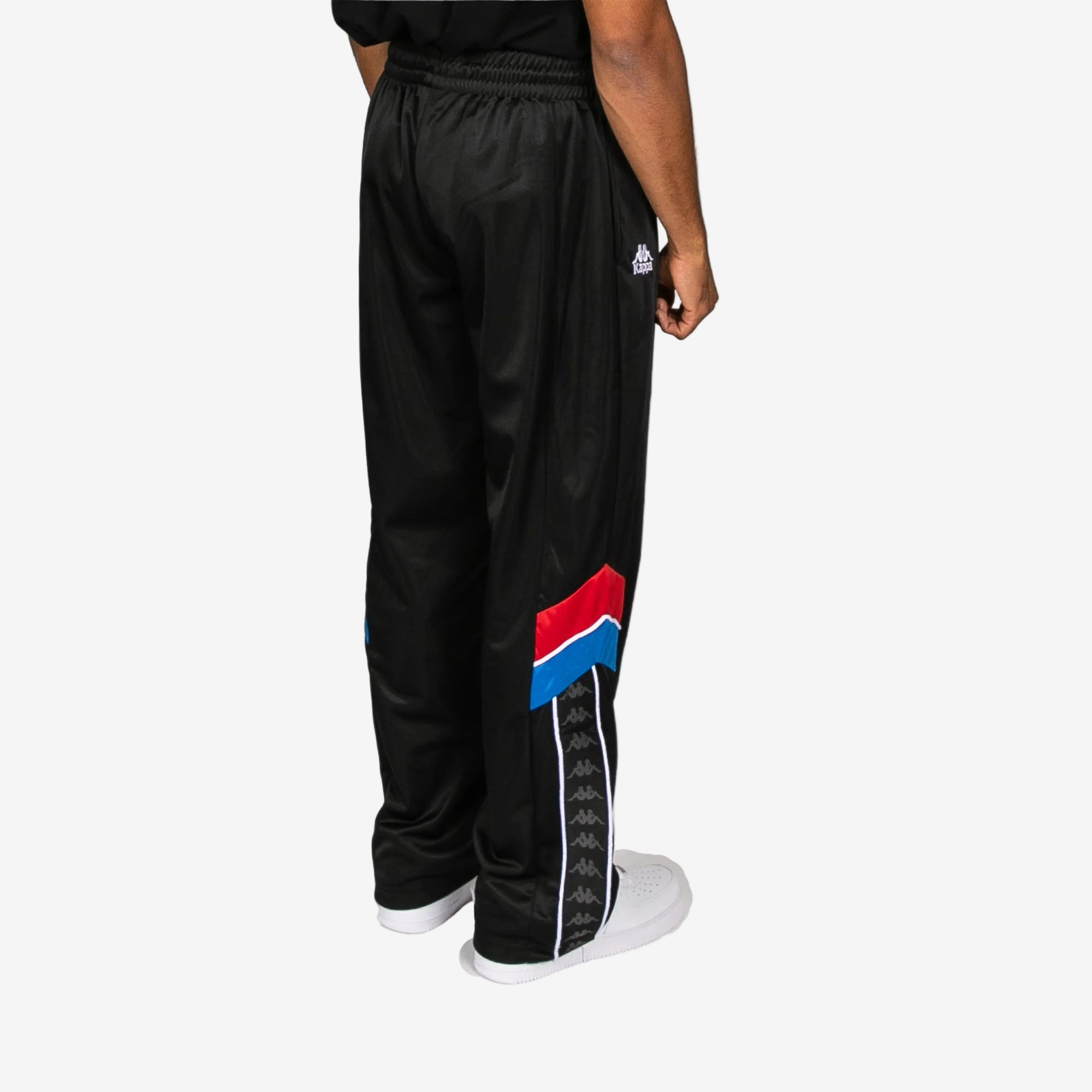 Black track pants with colorful design on a white background