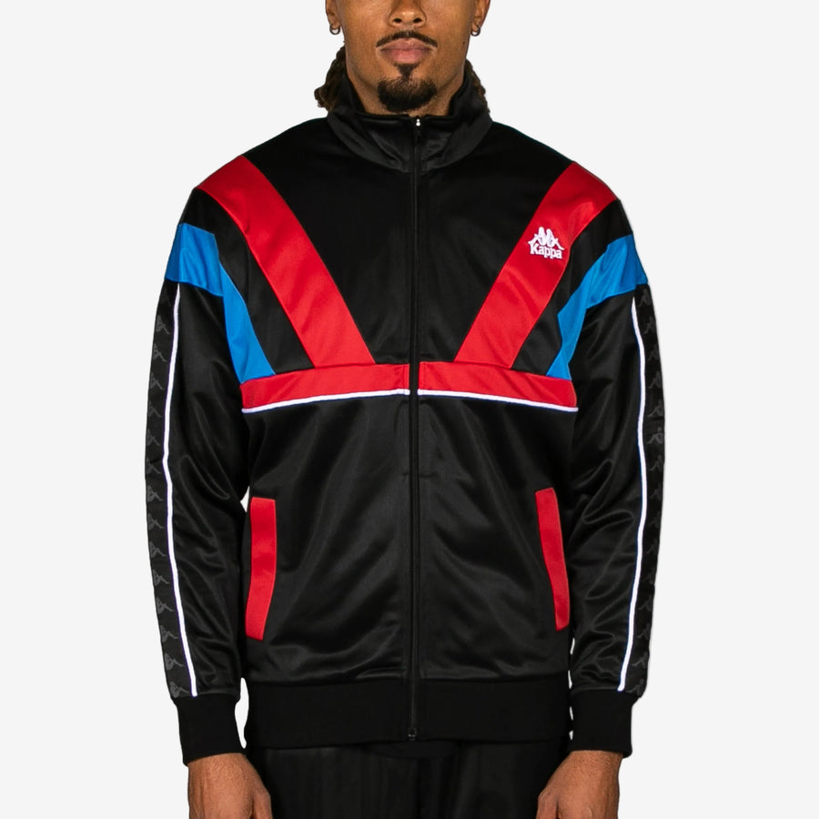 Person wearing a black jacket with red and blue accents on a white background