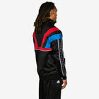 Person wearing a black tracksuit with red and blue accents on a white background
