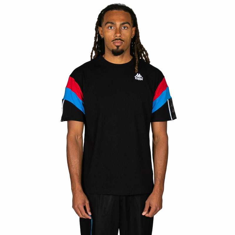 Person wearing a black t-shirt with colorful sleeves on a white background