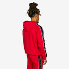 Person wearing a red tracksuit with black side panels on a white background