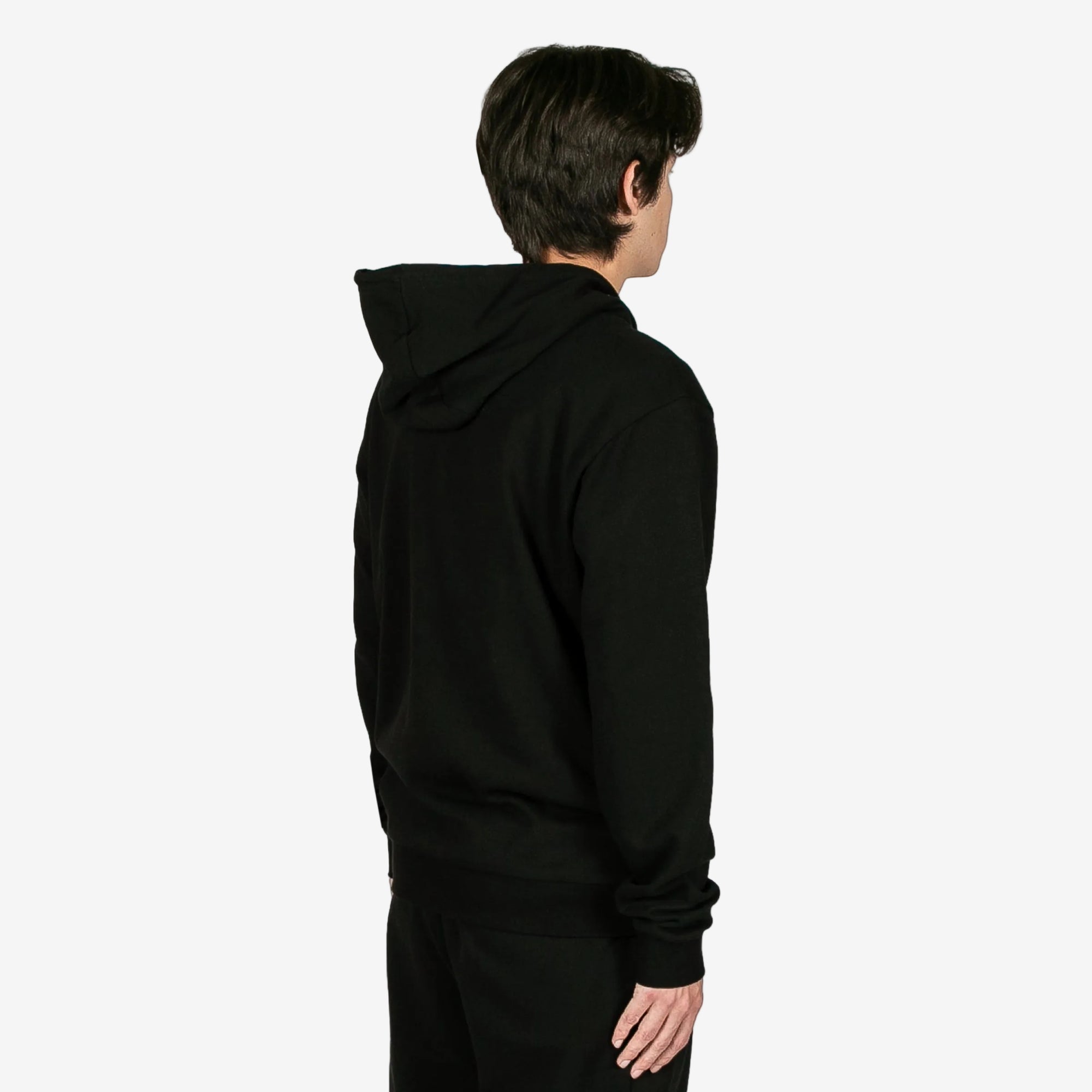 Person wearing a black hoodie from behind on a white background