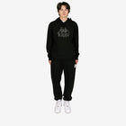 Person wearing a black Kappa hoodie and pants on a white background