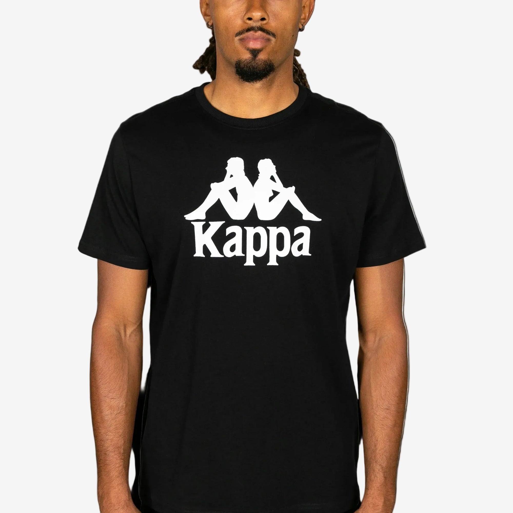 Person wearing a black Kappa t-shirt with white logo