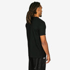 Person wearing a black t-shirt with a brand logo on the back, standing against a white background