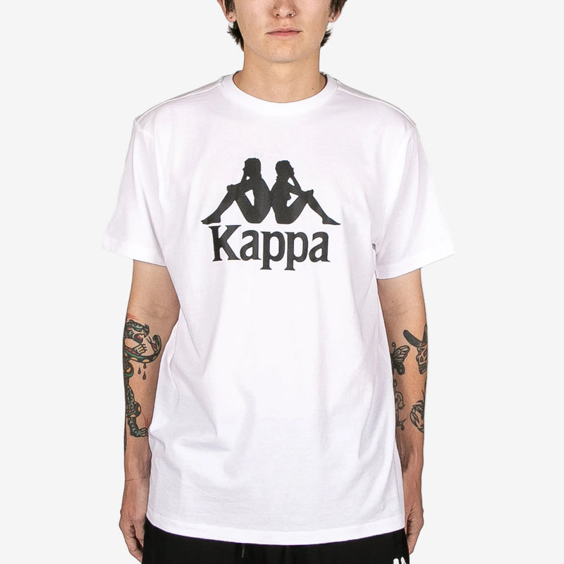 Person wearing a white Kappa t-shirt with black logo on a white background