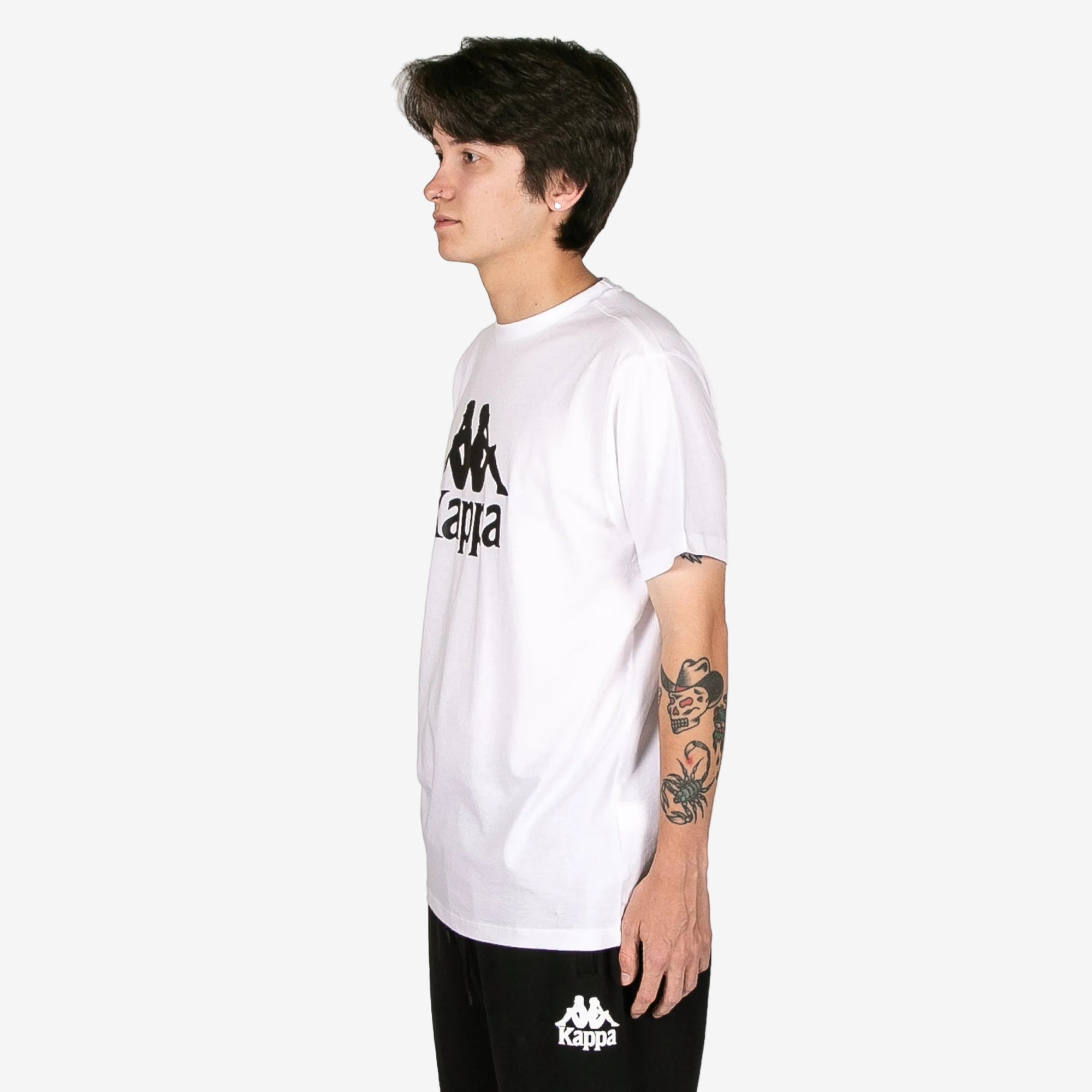 Person wearing a white Kappa t-shirt on a white background