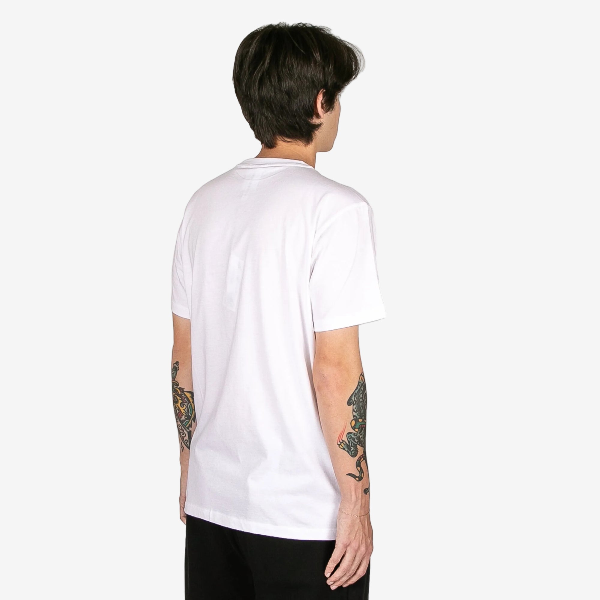 Person wearing a plain white t-shirt on a white background