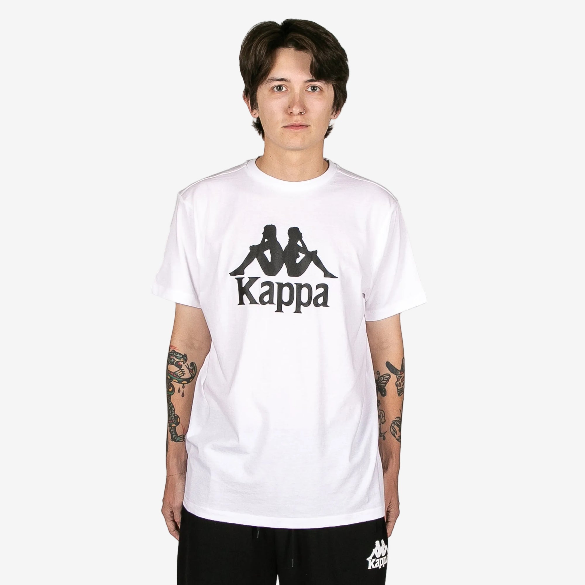 Person wearing a white Kappa t-shirt with black logo on a white background