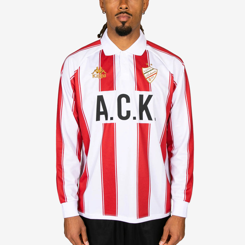 Person wearing a red and white striped sports jersey with 'A.C.K.' branding on a white background