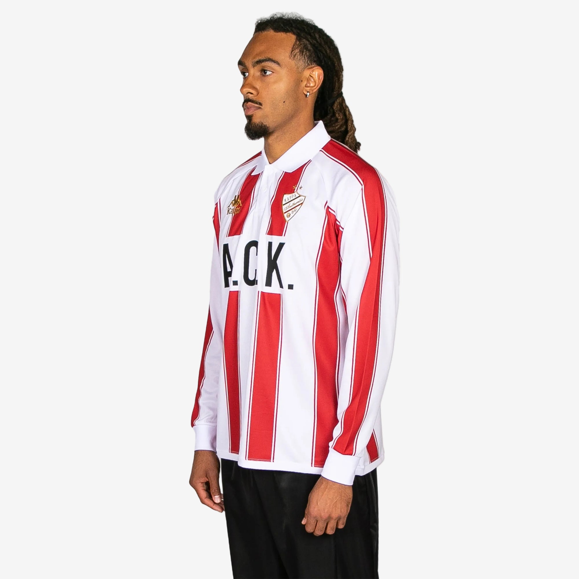 Person wearing a red and white striped shirt with 'A.C.K.' text on a white background