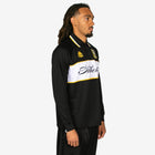 Person wearing a black and white sports outfit with visible branding on a white background