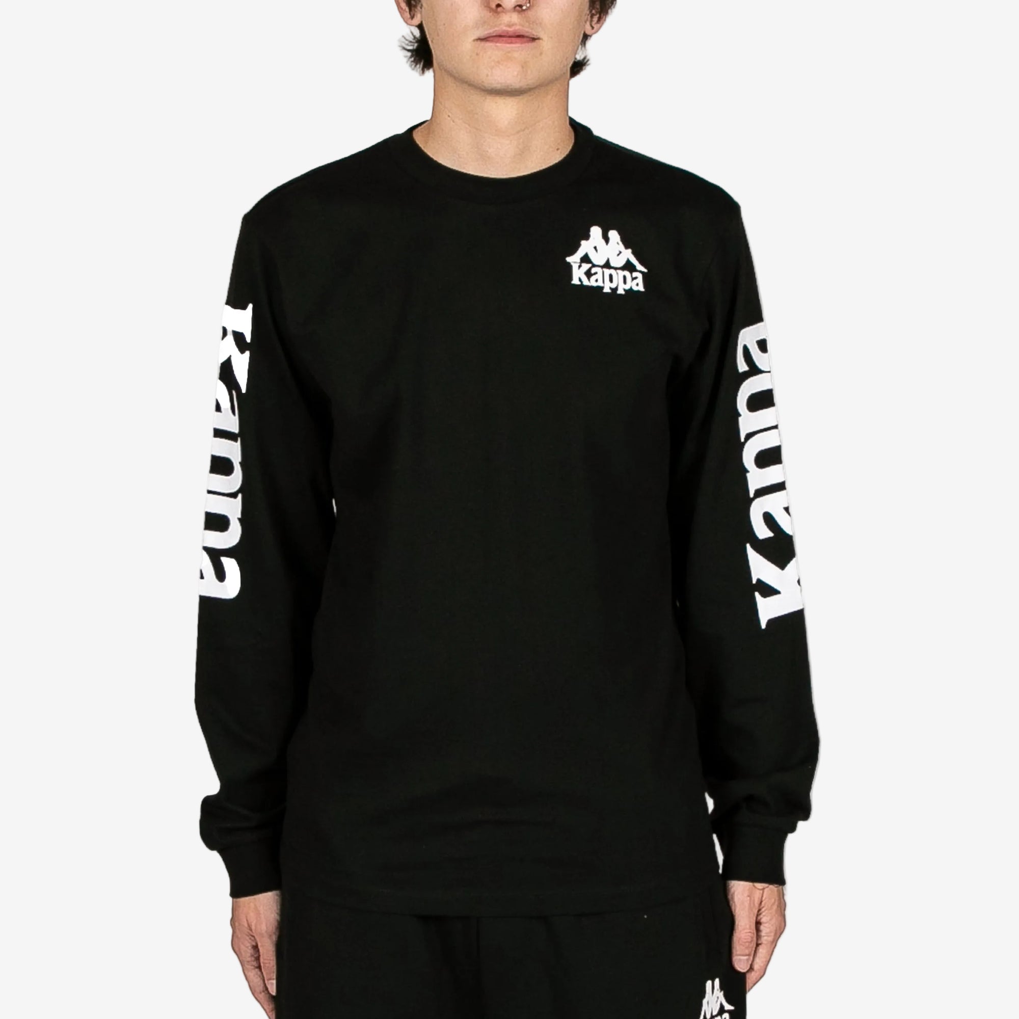 Person wearing a black long-sleeve shirt with Kappa branding on a white background